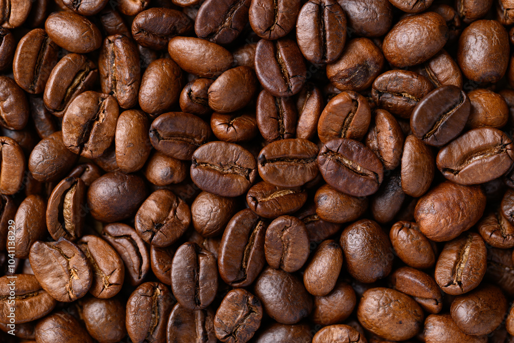 Naklejka premium Roasted coffee bean (Arabica coffee) texture background