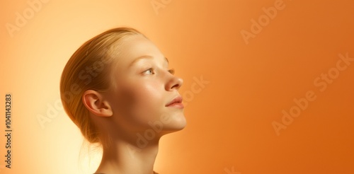 A woman with blonde hair and a pinkish orange background