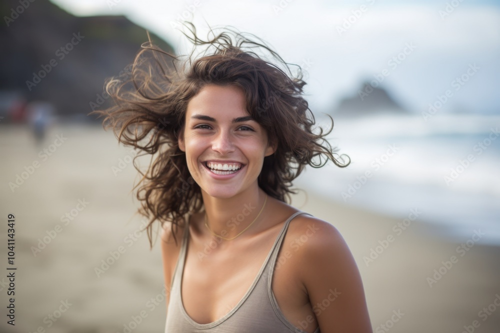 A woman with long hair is smiling and standing on a beach A woman with long hair is smiling and standing on a beach