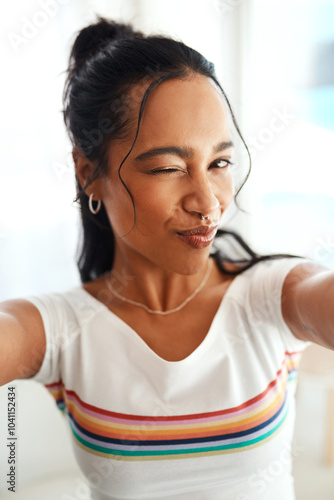 Obraz na płótnie Woman, portrait and wink selfie for profile picture, vlog or social media post at home