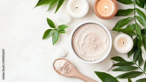 Skincare essentials with cream, candles, and natural leaves on a white background. photo