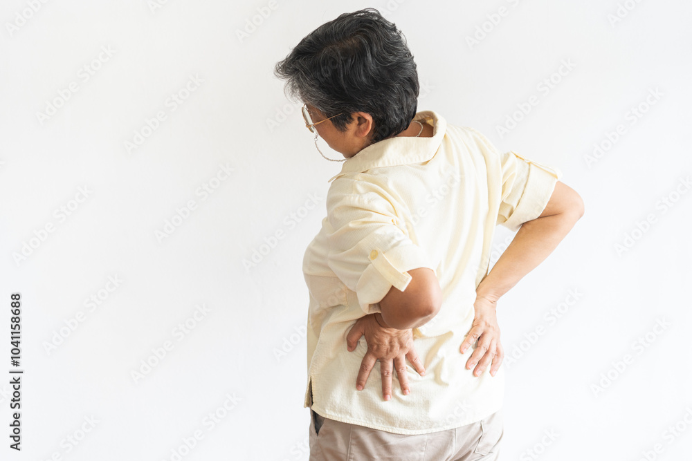 Pain body muscles stiff problem of senior, asian aged, old woman painful with back ache from work, hand holding massaging rubbing waist hurt, sore on white background. Health care and medicine concept Pain body muscles stiff problem of senior, asian aged, old woman painful with back ache from work, hand holding massaging rubbing waist hurt, sore on white background. Health care and medicine concept