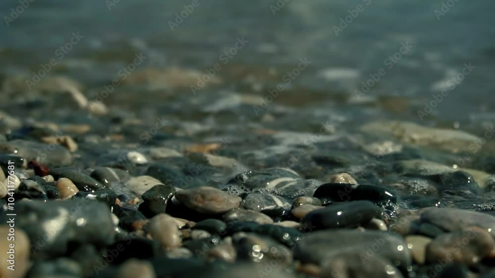 Tranquil waves gently lapping on pebble beach shoreline Tranquil waves gently lapping on pebble beach shoreline
