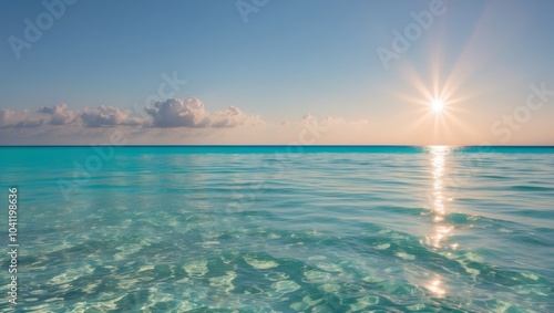 Crystal clear turquoise waters with sun reflections.