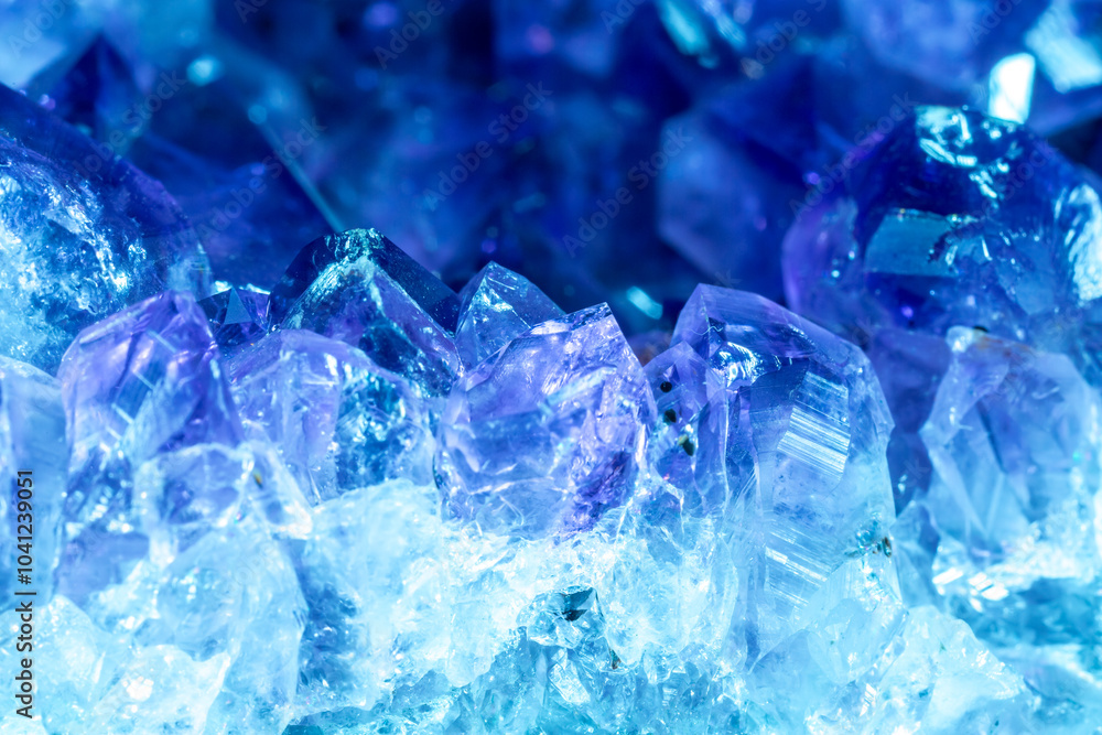 Blue Crystal Mineral Stone. Gems. Mineral crystals in the natural environment. Texture of precious and semiprecious stones. Seamless background with copy space colored shiny surface of precious stones Blue Crystal Mineral Stone. Gems. Mineral crystals in the natural environment. Texture of precious and semiprecious stones. Seamless background with copy space colored shiny surface of precious stones