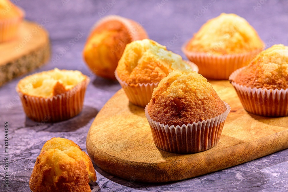 Freshly baked muffins on a wooden board. Freshly baked muffins on a wooden board.