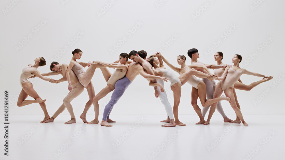 Naklejka premium Contemporary ballet group in flowing motion. Group of people, men and women, ballet dancers making impressive performance. Concept of art, classical dance, performance, theater