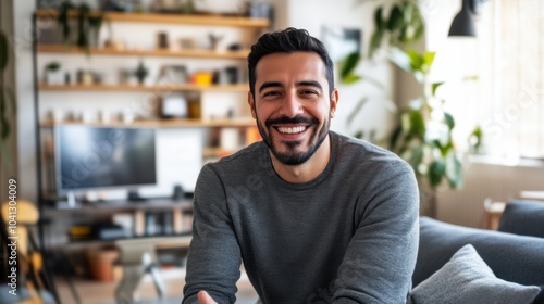 Hispanic man having a video conference at home