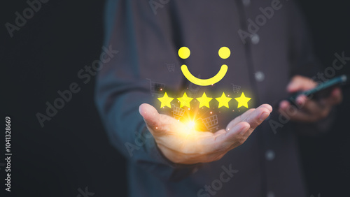 Person holding a glowing five-star customer review with a smile face, symbolizing high-quality service and positive customer satisfaction in online shopping, background features shopping cart icons. photo