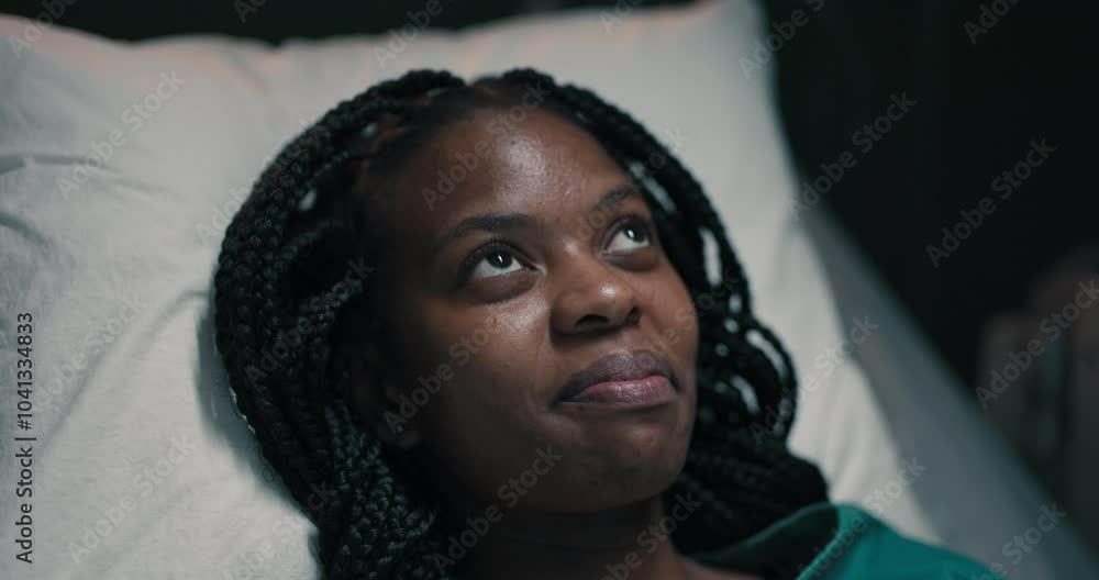 African woman patient, deep in thought, her gaze fixed above. African woman patient, deep in thought, her gaze fixed above.