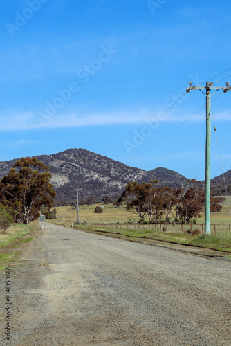 dirt road in rural australia and you yangs mountain range photo