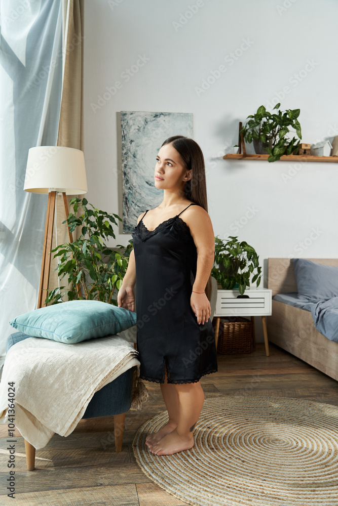 © LIGHTFIELD STUDIOS - A brunette young woman with short stature stands peacefully in her cozy living area, embracing a quiet moment of reflection in comfort.