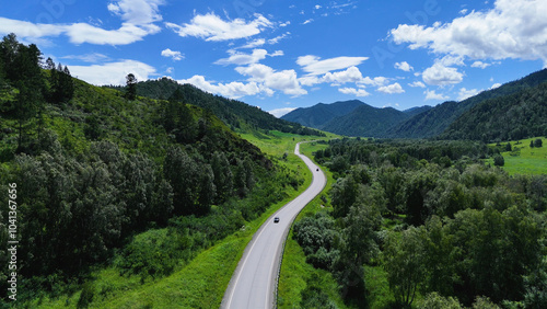 the car is driving along a mountain road in Altai