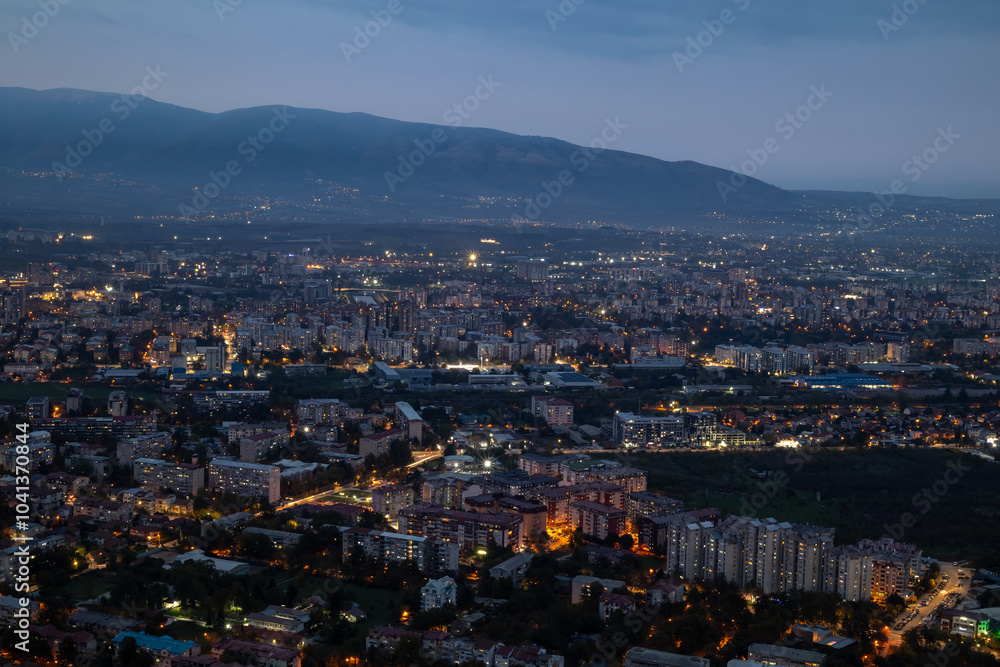 Obraz premium City illuminated at dusk, seen from above. The European capital of North Macedonia, Skopje.