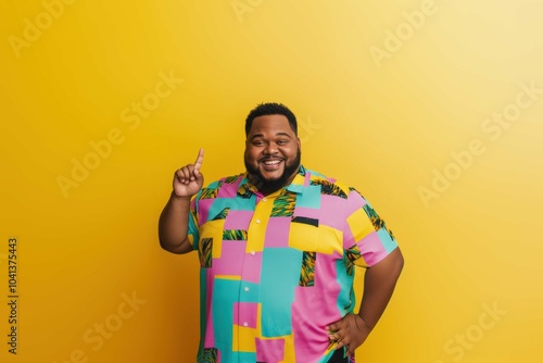 Cheerful Man Pointing Up in Colorful Shirt