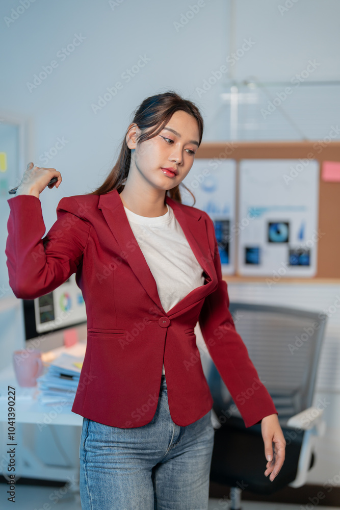 Stressed young manager in modern office taking a break, stretching shoulders, embodying success and professionalism Stressed young manager in modern office taking a break, stretching shoulders, embodying success and professionalism