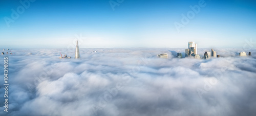 Obraz na płótnie Elevated, panoramic view of the skyline of London, England, during fog with only the tips of the skyscrapers looking out above the clouds w salonie