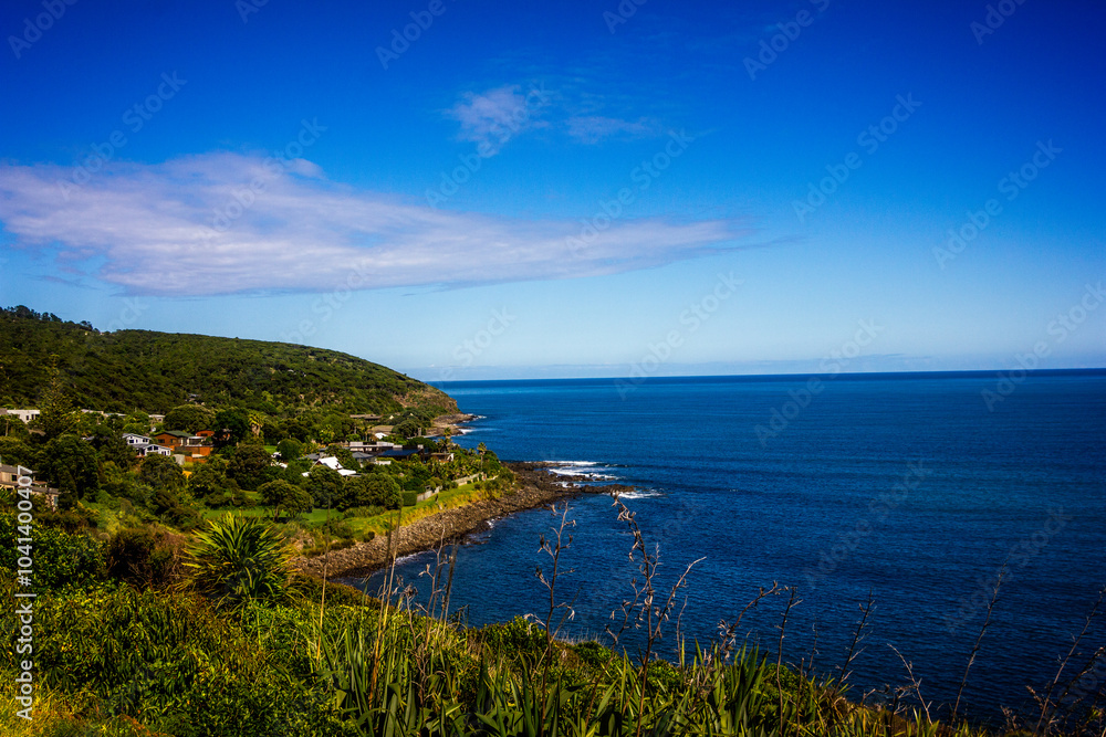 Panoramic view over high coast of Tasman Sea on an overcast summer day. High vantage point. Raglan, New Zealand Panoramic view over high coast of Tasman Sea on an overcast summer day. High vantage point. Raglan, New Zealand