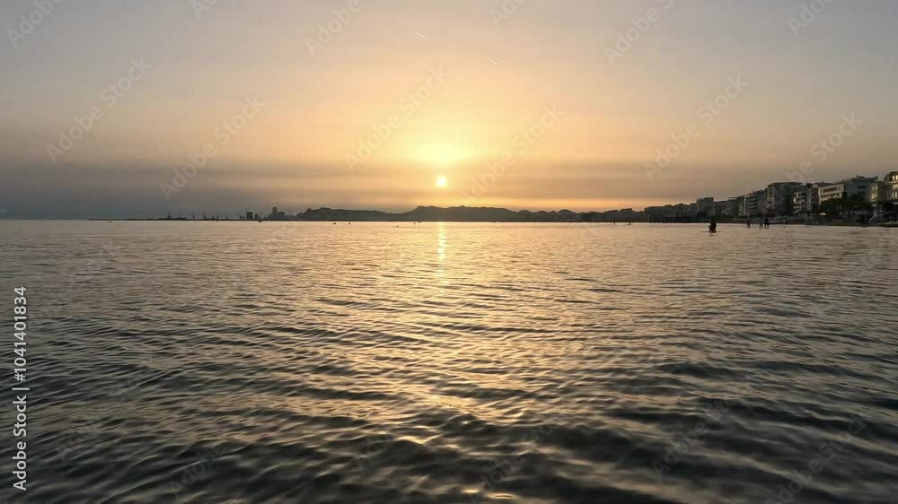 Durres beach on sunset, skyline against a backdrop of soft clouds and tranquil waters making a dreamy landscape. Durres beach on sunset, skyline against a backdrop of soft clouds and tranquil waters making a dreamy landscape.