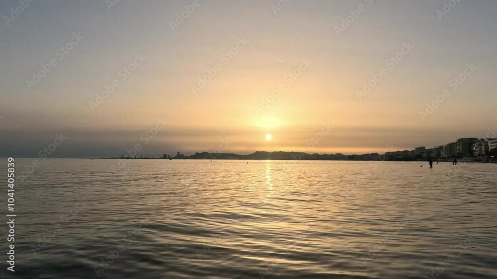 Durres beach on sunset, skyline against a backdrop of soft clouds and tranquil waters making a dreamy landscape. Durres beach on sunset, skyline against a backdrop of soft clouds and tranquil waters making a dreamy landscape.