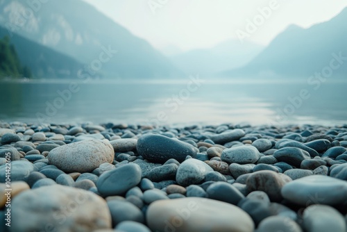 Ground level angle view, surface of smooth river stone, with a cinematic surrounding of hazy alpine lakeside, cool gray lighting, and soft blue hues, showcasing copy space, ad promo template