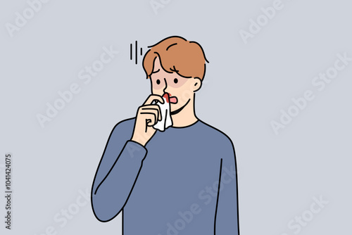 Blood from nose in sick man suffering from intracranial pressure or dangerous virus that reduces stability of vessels. Blood from nose causes stress and discomfort in guy holding nasal tissue