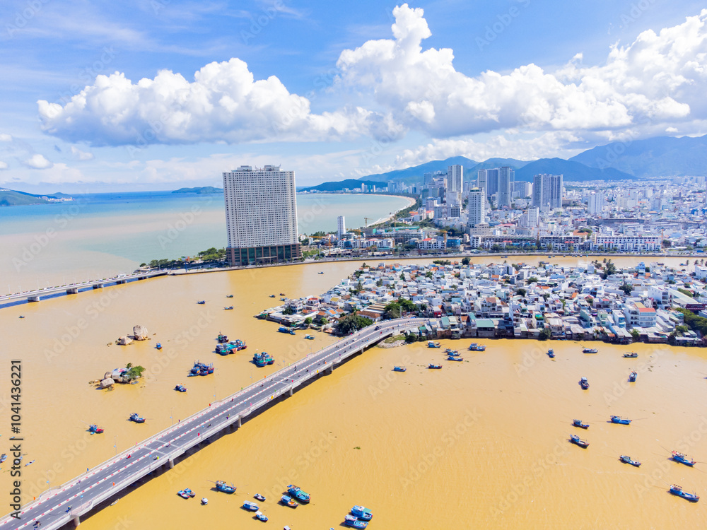 Naklejka premium The Kai River in Nha Trang.A resort town in Vietnam. October is the rainy season. The water in the river rises and turns red due to the muddy bottom and the flow of water from the mountains. 