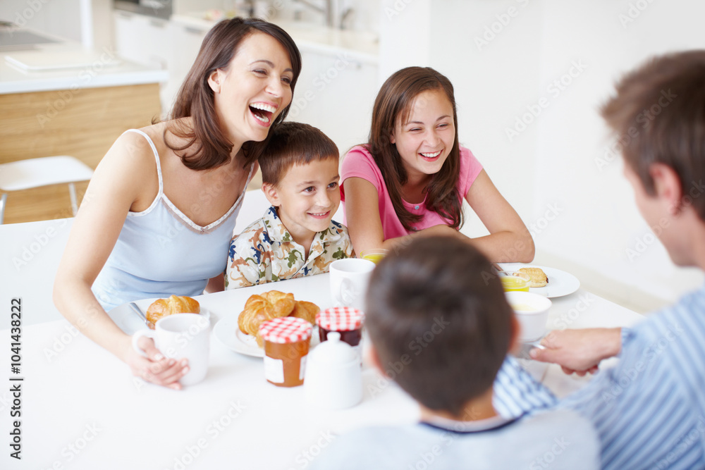 Family, laughing and morning breakfast in home, dining table and support with eating healthy food. Parents, children and funny conversation in kitchen with meal, love and brunch nutrition for bonding Family, laughing and morning breakfast in home, dining table and support with eating healthy food. Parents, children and funny conversation in kitchen with meal, love and brunch nutrition for bonding