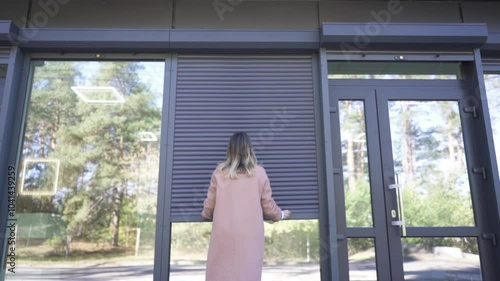 Female Business Owner of Local Store opening garage storefront