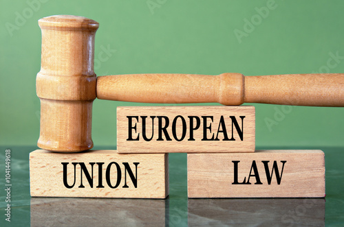 EUROPEAN UNION LAW - words on wooden blocks with a judge's gavel in the background photo