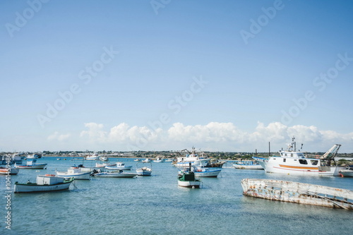 fishing boats in harbour in Portopalo in Sicily photo