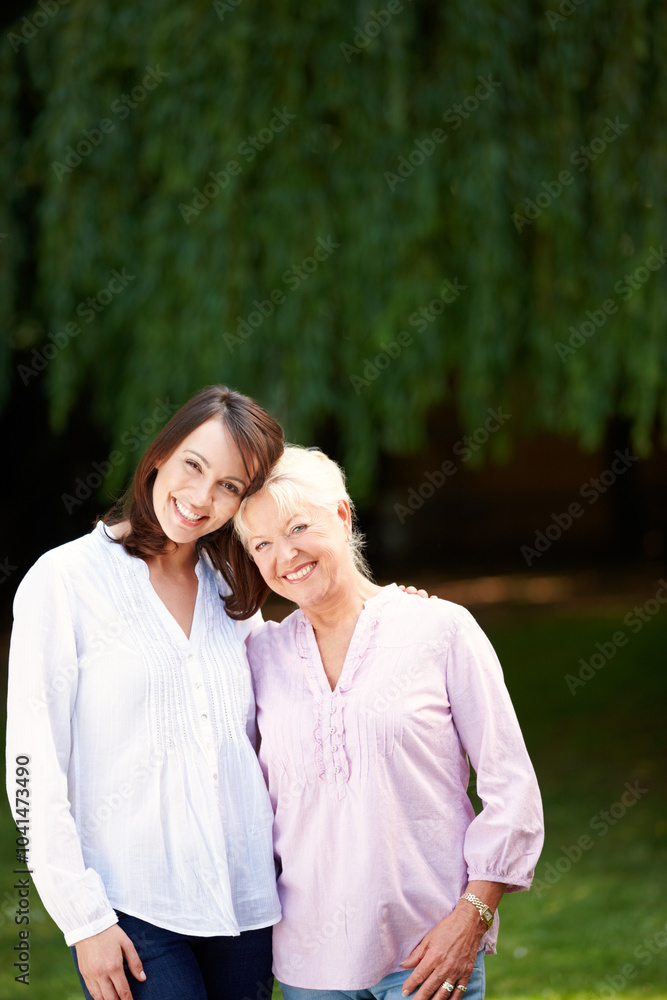 Fototapeta premium Park, senior mother and woman in portrait with hug, connection and bonding together as family. Happy people, mom and adult daughter with smile for memory, security and love on holiday in Australia