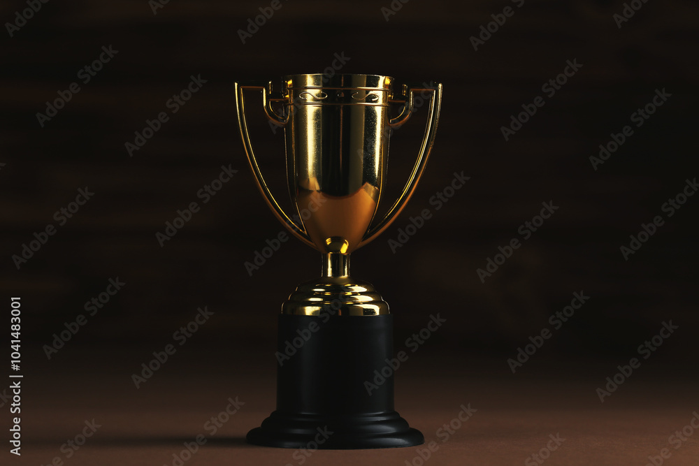 Golden trophy cup on black background