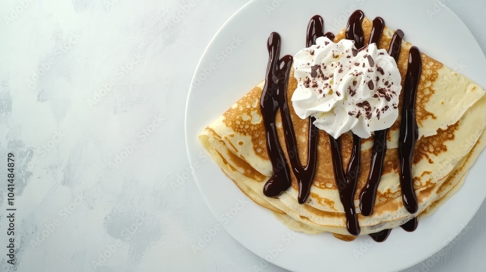 Sweet festival crepes with chocolate sauce and whipped cream, top view, copy space, no people Sweet festival crepes with chocolate sauce and whipped cream, top view, copy space, no people