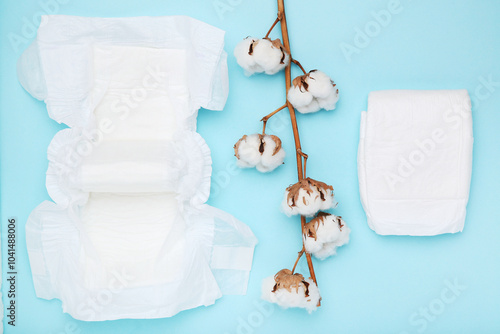 Obraz na płótnie Baby diapers with cotton flowers on blue background w salonie