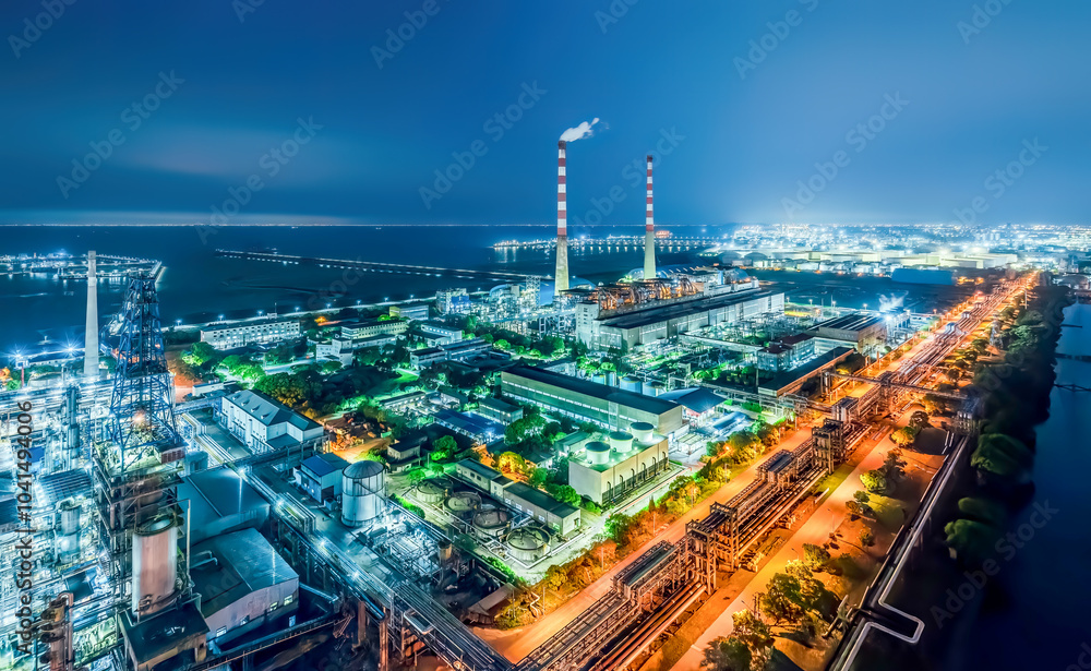 Obraz premium Refinery chemical plant industrial equipment in large industrial area at night