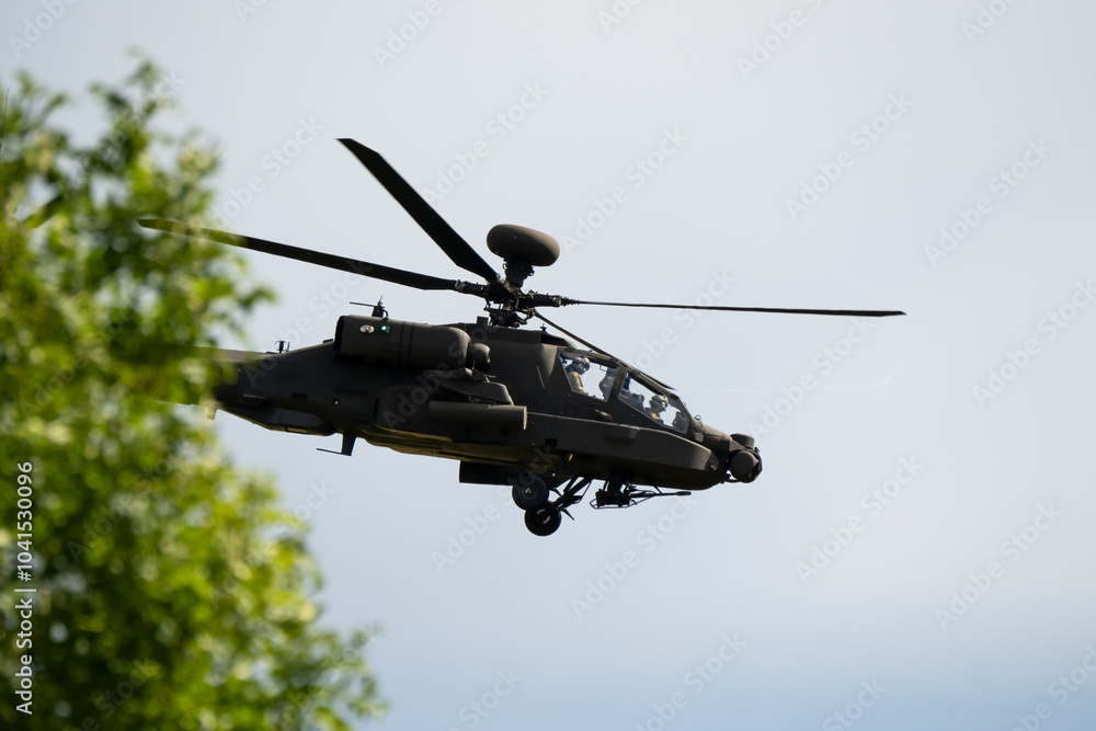 Fototapeta premium close-up side view of a British army Boeing Apache Attack helicopter gunship AH64E AH-64E ArmyAirCorp in low level flight