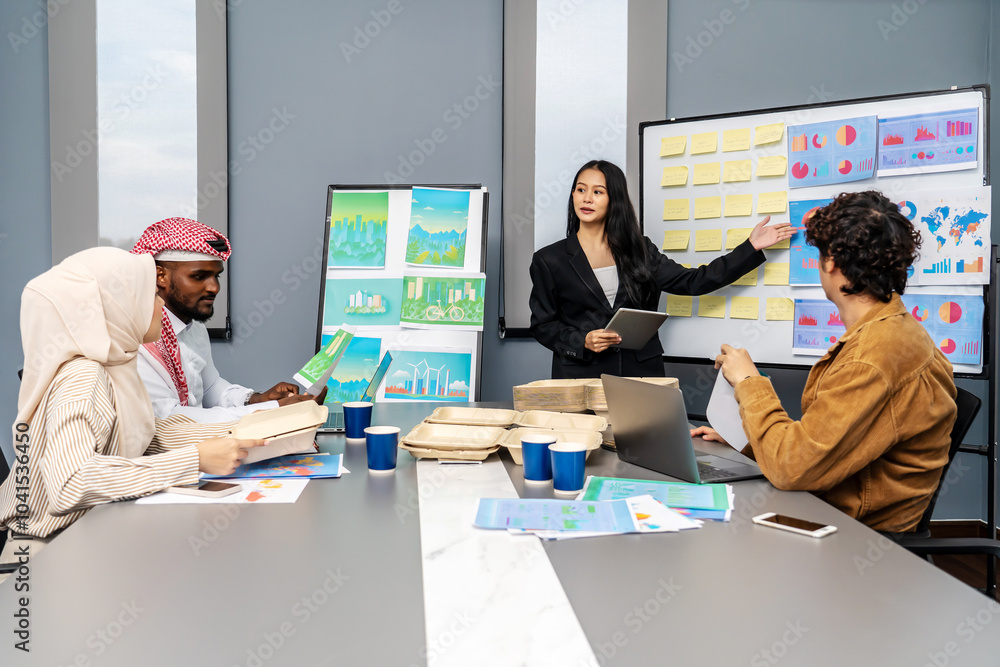 Asian businesswoman presents project strategies to a diverse team during a meeting, planning and development strategy using graphs, charts, presented at company sales strategy marketing meeting Asian businesswoman presents project strategies to a diverse team during a meeting, planning and development strategy using graphs, charts, presented at company sales strategy marketing meeting