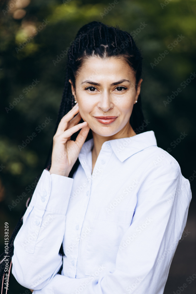 Portrait of young woman with braided hair in park Portrait of young woman with braided hair in park