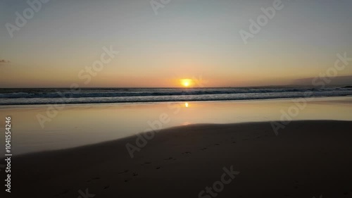 Wallpaper Mural Serene sunset view over tranquil beach and ocean waves in Caparica, Portugal. Torontodigital.ca