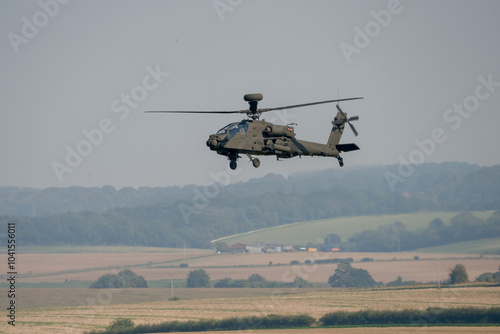 close-up side view of a British army Boeing Apache Attack helicopter gunship AH64E AH-64E ArmyAirCorp in low level flight