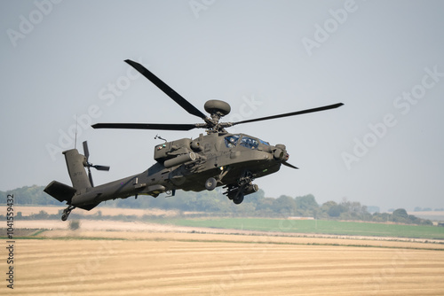 close-up side profile of British army Boeing Apache Longbow Attack helicopter gunship ZM733 AH64E AH-64E ArmyAirCorp in low level banking flight