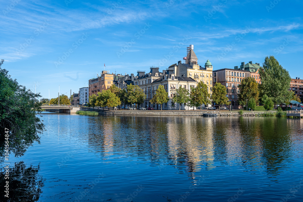 Fototapeta premium Motala Stream and Norrköping waterfront during early autumn in Sweden in the middle of September 2024