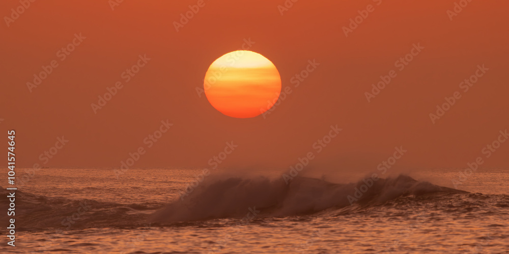 Beautiful sunset over the ocean with a glowing sun and soft waves, creating a peaceful and tranquil scene. Perfect for concepts of relaxation, nature, and calm atmospheres. Ideal for backgrounds. Beautiful sunset over the ocean with a glowing sun and soft waves, creating a peaceful and tranquil scene. Perfect for concepts of relaxation, nature, and calm atmospheres. Ideal for backgrounds.