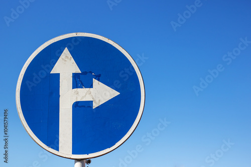 There is a blue sign featuring an arrow that points to the right