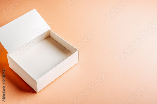 Minimalist open white box on neutral peach background for product mockup and design photo