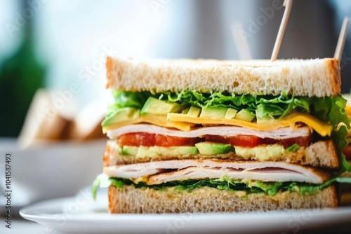 A close-up of a delicious sandwich stacked with layers of fresh ingredients- turkey, lettuce, tomatoes, cheese, and avocado, all between golden, toasted bread, with vibrant colors and textures