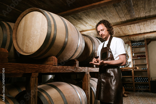 Young man sommelier with a glass of red wine
