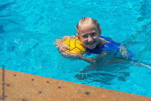 Water polo player with a yellow ball