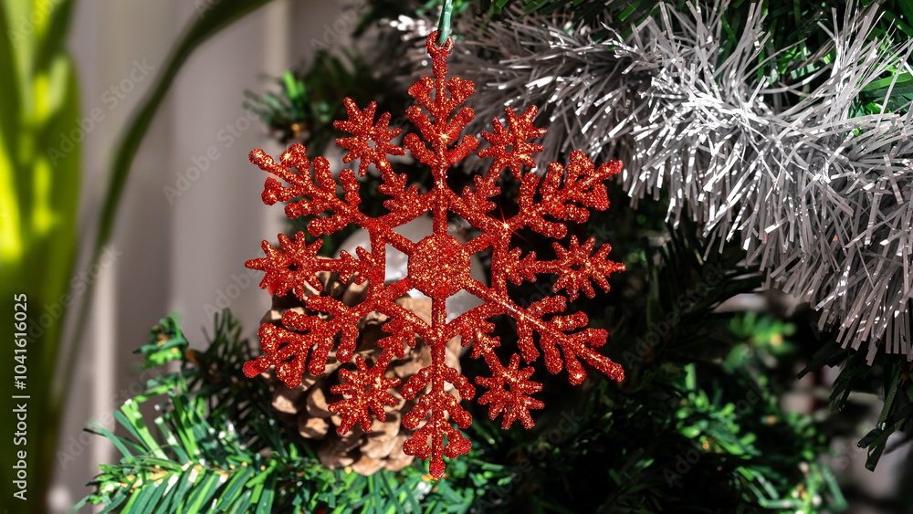 Adorned with holiday red snowflake, a festive Christmas snow flake hang on tree Adorned with holiday red snowflake, a festive Christmas snow flake hang on tree